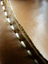 Macro shot of a fragment of a shoe with laces made from thick brown leather