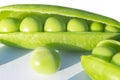 Macro shot fresh green peas with beans isolated on white background. Sweet peas in close up isolated over white with clipping path Royalty Free Stock Photo