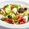 Macro Shot of Greek Salad in Light Plate Isolated on White Background Royalty Free Stock Photo