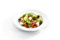 Macro Shot of Greek Salad in Light Plate Isolated on White Background Royalty Free Stock Photo