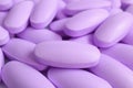 Macro shot of heap of pastel purple oval shaped supplement pills Royalty Free Stock Photo