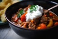 Macro shot of a hot and spicy goulash with chunks of tender beef and vegetables, simmered to perfection