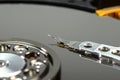 Macro shot of a magnetic needle on a hard disk platter, open HDD disk, perfectly clean surface.