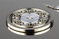 Macro shot of a magnetic needle on a hard disk platter, open HDD disk, perfectly clean surface, visible screws fixing the plates. Royalty Free Stock Photo