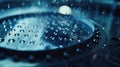 A macro shot of a microchip fabrication machine showing tiny droplets of graphene being carefully p on a silicon wafer