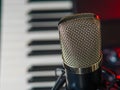 Macro shot. Microphone and midi keyboard, synthesizer. Recording studio, radio, music, place of work of a composer, musician, Royalty Free Stock Photo