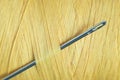 A macro shot of a needle and a spool of yellow thread. Royalty Free Stock Photo