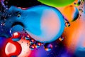 Macro shot of oil bubbles with water on colorful background. Space and universe planets styled psychedelic abstract image Royalty Free Stock Photo