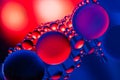 Macro shot of oil bubbles with water on colorful background. Space and universe planets styled psychedelic abstract image Royalty Free Stock Photo