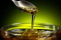 Macro shot of olive oil being poured delicately into a gleaming spoon Royalty Free Stock Photo