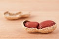 Macro shot of an opened peanut on a wooden table Royalty Free Stock Photo