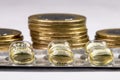 Macro shot pile of tablets pill in silver aluminium blister packaging with money coins background