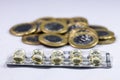 Macro shot pile of tablets pill in silver aluminium blister packaging with money coins