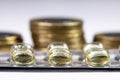 Macro shot pile of tablets pill in silver aluminium blister packaging with money coins