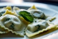 Macro shot of a plate of colorful ravioli pasta stuffed with spinach and ricotta cheese