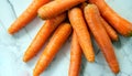 macro shot of scattered carrots on a white marble table top view