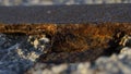 Macro shot of a section of an abandoned rusty rail track impressed in concrete Royalty Free Stock Photo