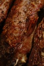 A macro shot of several turkey wings baked in the oven until golden brown with spices.