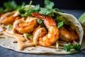 Macro shot of a shrimp taco with a soft flour tortilla, featuring a close-up of the plump and succulent grilled shrimp