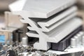 Macro shot of a silver heat sink dissipating heat from the power section on the motherboard of a desktop computer. Royalty Free Stock Photo