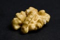 Macro Shot of Single Walnut Kernel on Black Background Royalty Free Stock Photo