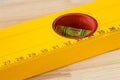 Macro shot of a spirit level with ruler on a wooden background Royalty Free Stock Photo