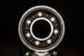 Macro shot of stainless steal bearing. New replacement roller skate bearings isolated on black background. Standard ABEC type