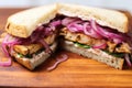 macro shot of a tempeh sandwich with sauteed onions