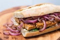 macro shot of a tempeh sandwich with sauteed onions