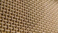 Macro shot of the texture of a fibrous threads, checkered structure surface. Beige and brown threads are intertwined in