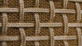 Macro shot of the texture of a fibrous threads, checkered structure surface. Beige and brown threads are intertwined in