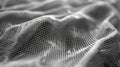 A macro shot of a thin lightweight material with a rippled surface. The material is folded and rolled into small