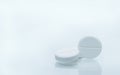 Macro shot of three white chewable tablets on white background