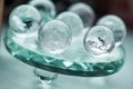 Macro shot of transparent crystal balls with colorful ornaments and sun reflections in it Royalty Free Stock Photo