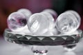 Macro shot of transparent crystal balls with colorful ornaments and sun reflections in it Royalty Free Stock Photo