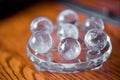 Macro shot of transparent crystal balls with colorful ornaments and sun reflections in it Royalty Free Stock Photo