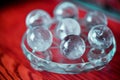 Macro shot of transparent crystal balls with colorful ornaments and sun reflections in it Royalty Free Stock Photo