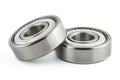 Macro shot of two ball bearings, isolated on a white background, selective focus. Royalty Free Stock Photo