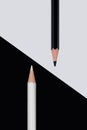 Black and white pencils with opposite colored background Royalty Free Stock Photo