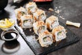Macro shot of uramaki sushi rolls with cream cheese, fried salmon, tuna shavings or dried bonito, cucumber, nori. Fresh katsuobush