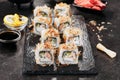 Macro shot of uramaki sushi rolls with cream cheese, fried salmon, tuna shavings or dried bonito, cucumber, nori. Fresh katsuobush