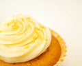 A macro shot of vanilla frosting on a cupcake