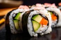 macro shot of a vegetarian sushi roll with carrots, cucumber, avocado, and pickled radish