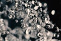 Macro Shot Of Water Drops Frozen In The Air, Levitating On Dark