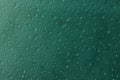 Waterdrops on glassplate with darkgreen background