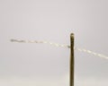 Macro shot of a white thread passing through the eye of a needle Royalty Free Stock Photo