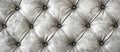 Macro shot of a white tufted leather couch with black buttons Royalty Free Stock Photo