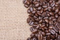 Macro shot of whole bean organic smooth medium dark roast coffee from Sumatra on burlap