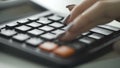 Macro shot of Womans fingers using a large button calculator