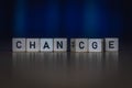 Macro shot of wooden cubes on a table showing the word CHANGE or CHANCE Royalty Free Stock Photo